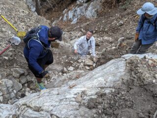 Volunteers building a crib wall out of rock on the trail to Sturtevant Camp